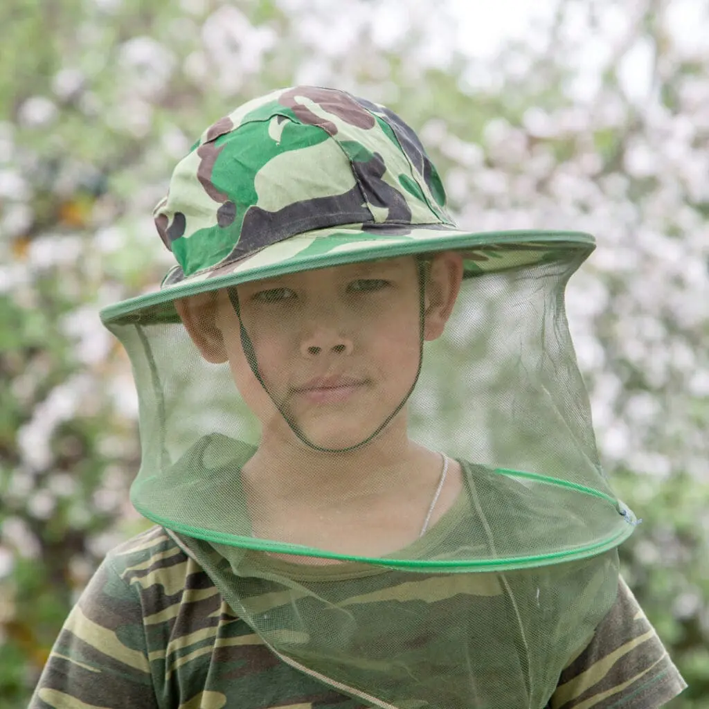 A boy wearing a mosquito hat