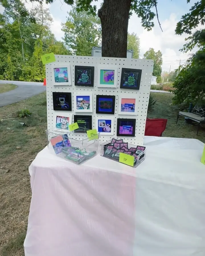 A craft fair booth with Dead Tech pins sitting on the table