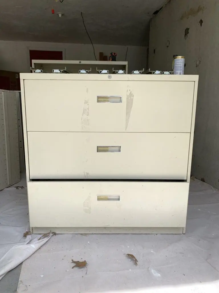 large beige office file cabinet sitting in a garage