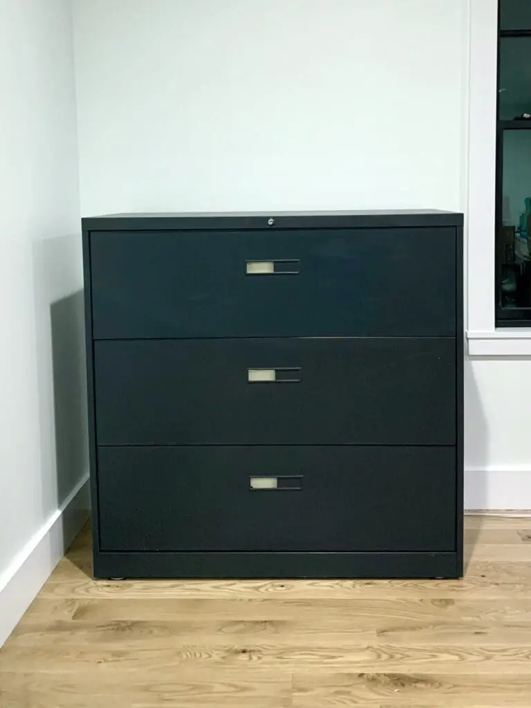 large file cabinet that has been painted a very dark green that looks almost black