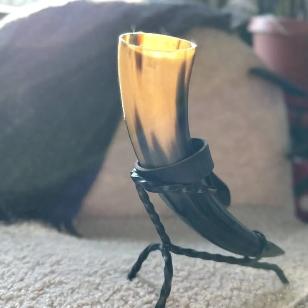 A viking drinking horn in a metal stand